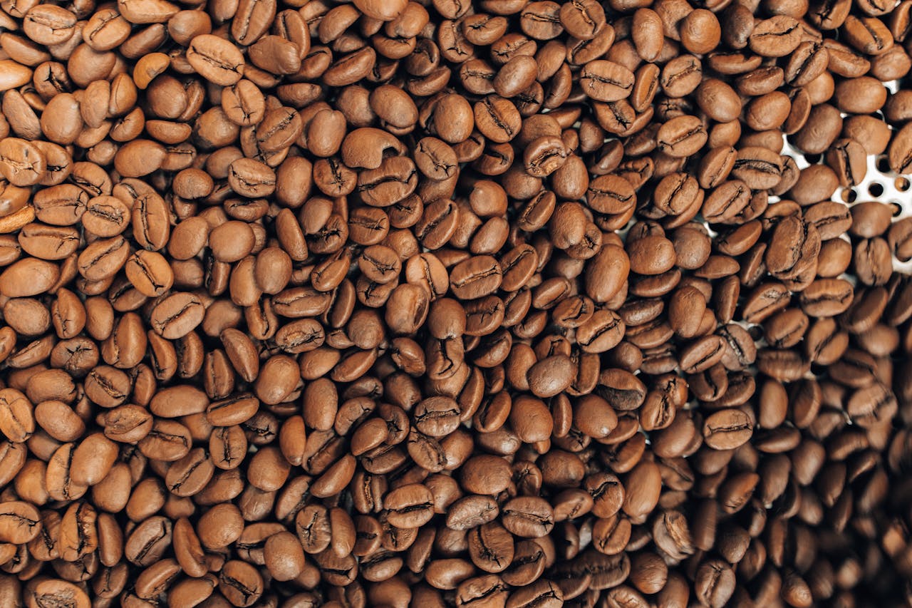 Detailed close-up of roasted brown coffee beans showcasing their texture and natural color.